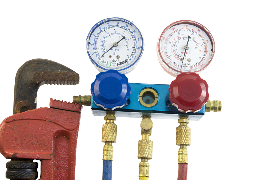 air conditioning manifold with high and low pressure gauges and valves commonly used in HVAC maintenance
